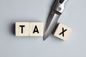 A scissor cutting the word Tax explaining the Marketing Expense Deductions for Content Creators