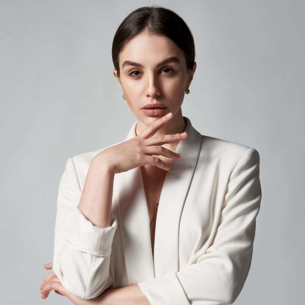 A confident professional woman in a white blazer represents expertise in OnlyFans taxes and financial advice.